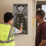 Residential electrician discussing electrical panel options with homeowner